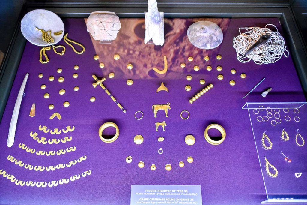 Artifacts from Grave 36, including gold bracelets and necklaces, showcasing intricate designs.