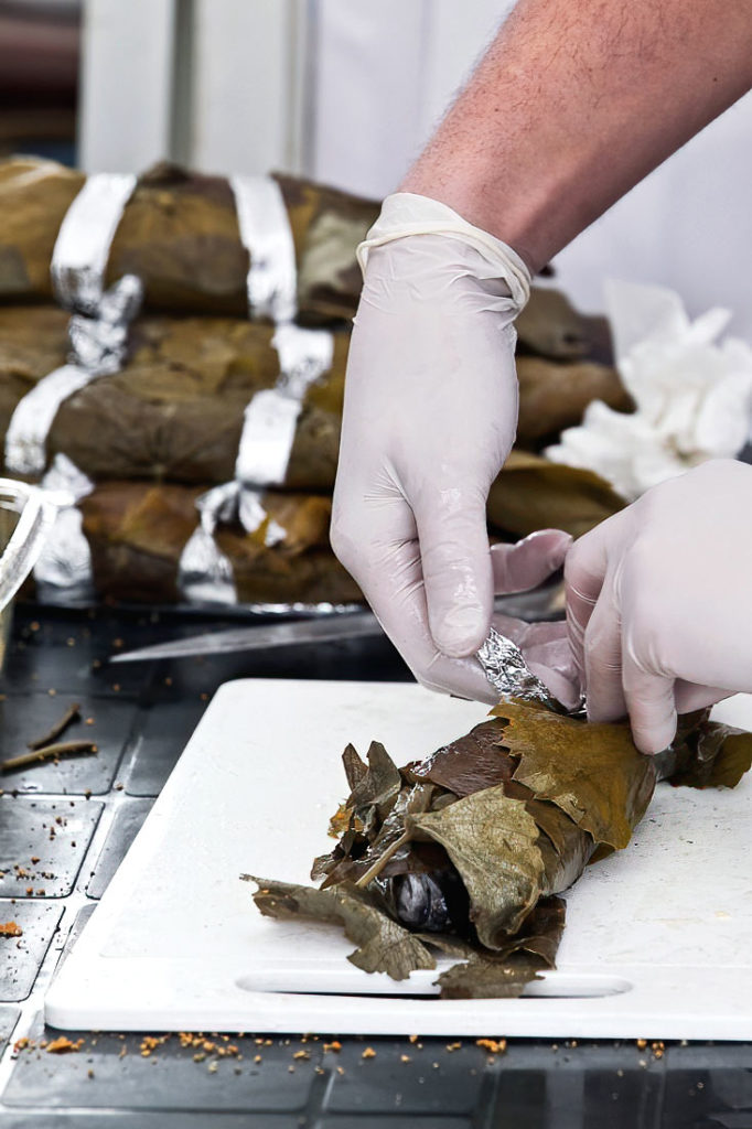 Oven-Baked Trout with Mushrooms in Vine Leaves, Bacon, and Herbs - Traditional Bulgarian Recipe.
